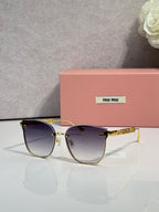 MiuMiu glasses with dark blue lenses and gold metal frame