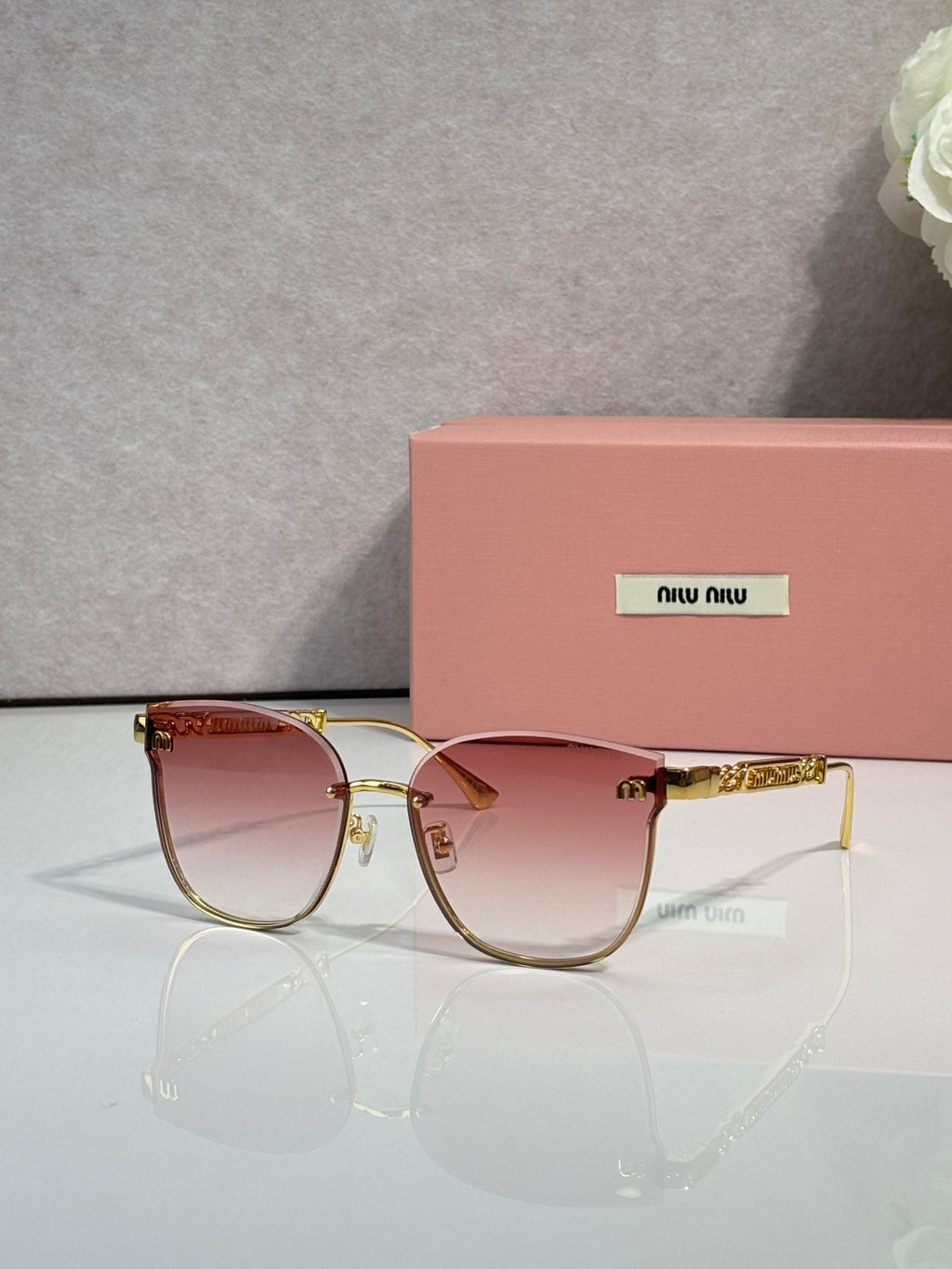 MiuMiu glasses with gold frame and pink tinted lenses