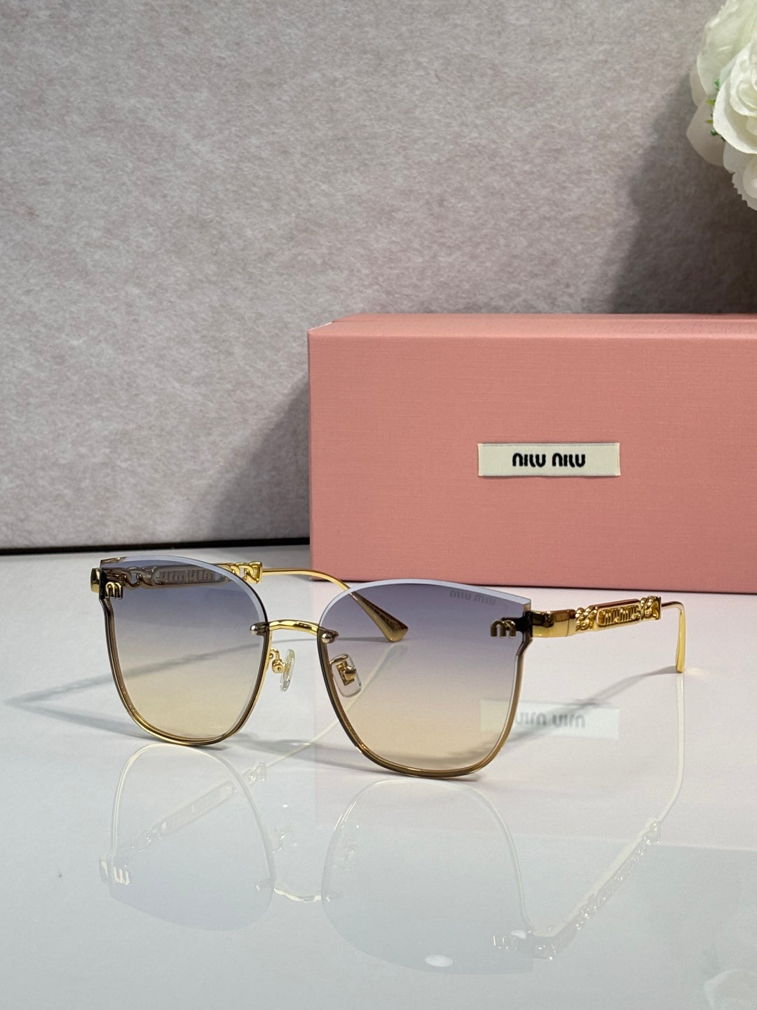 MiuMiu glasses with gold frame and light amber tinted lenses