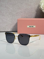 MiuMiu glasses with dark lenses and gold metal frame