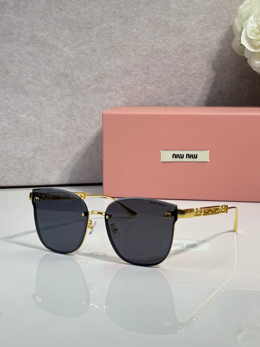 MiuMiu glasses with dark lenses and gold metal frame