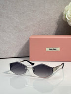 Sunglasses with black frames, gold accents, dark gray gradient lenses
