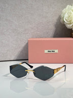 Sunglasses with black frames, gold detail, dark gray gradient lenses