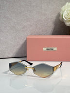 Sunglasses with black frames, gold bridge, light yellow gradient lenses