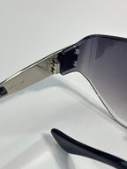 Sunglasses side view: silver temples with black tips and metal hinges