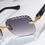 Close-up of gold-tone round sunglasses with purple gradient lenses and patterned bridge