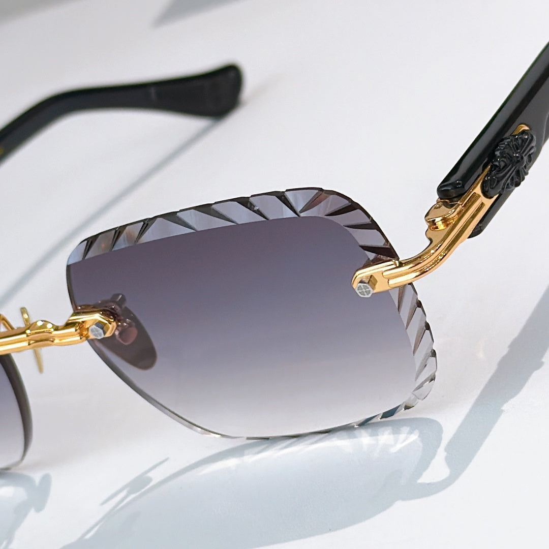 Close-up of gold-tone round sunglasses with purple gradient lenses and patterned bridge