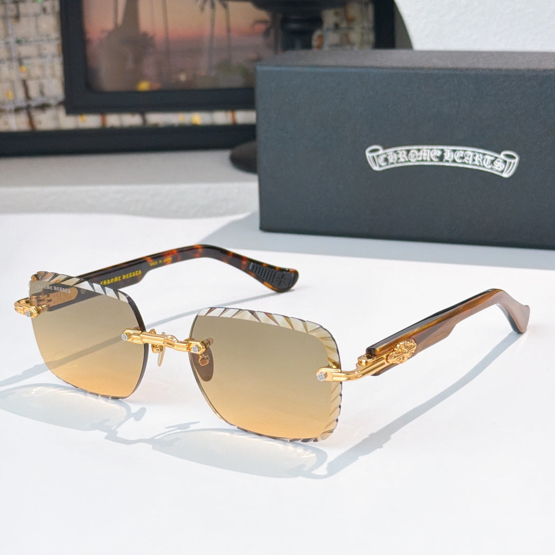 Gold-tone round sunglasses with amber gradient lenses and patterned temples