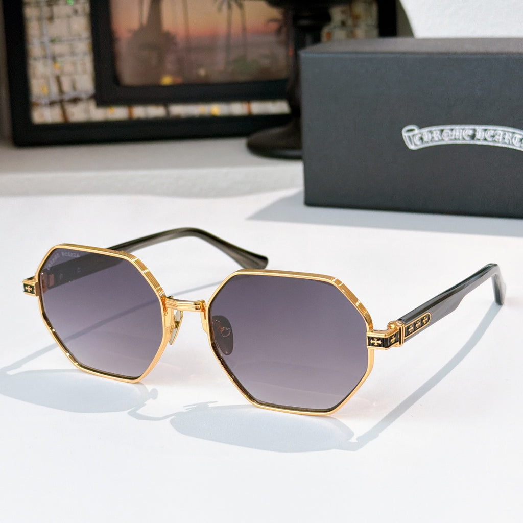 Octagonal sunglasses with gold frame and dark-tinted lenses, with patterned temple accents
