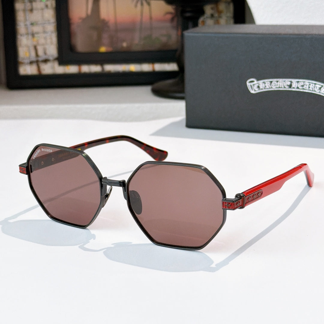 Octagonal sunglasses with dark frames, brown-tinted lenses, and red temple arms
