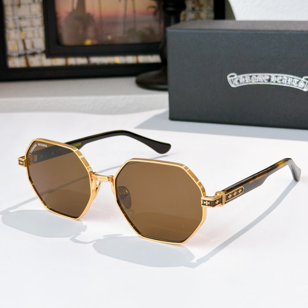 Octagonal sunglasses with gold frame and dark lenses, featuring patterned temple details