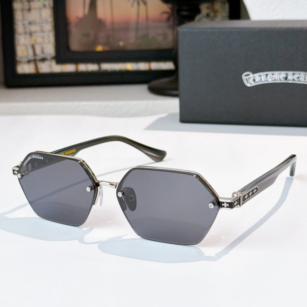 Gold sunglasses with dark gray hexagonal lenses and metal temple logo detail