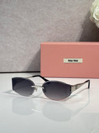 MiuMiu cat-eye sunglasses with dark navy lenses, maroon frame, gold accents