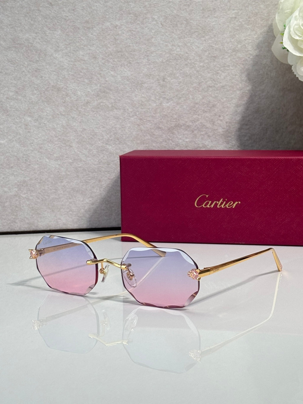 Gold-tone octagon eyeglasses with pink tint lenses