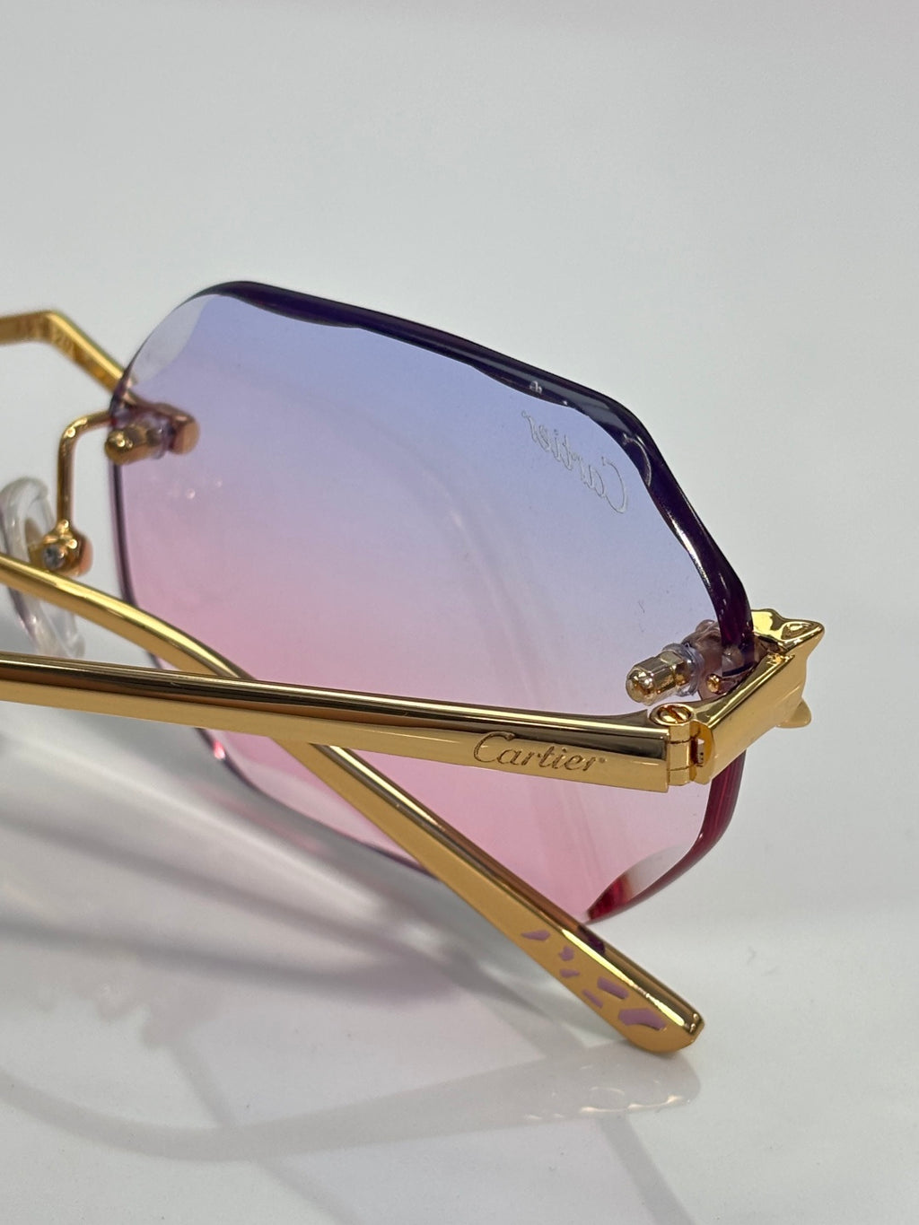 Gold-tone octagon sunglasses with purple-to-blue gradient lenses