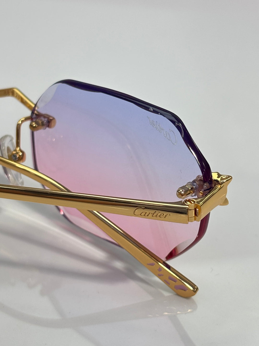 Gold-tone octagon sunglasses with purple-to-blue gradient lenses