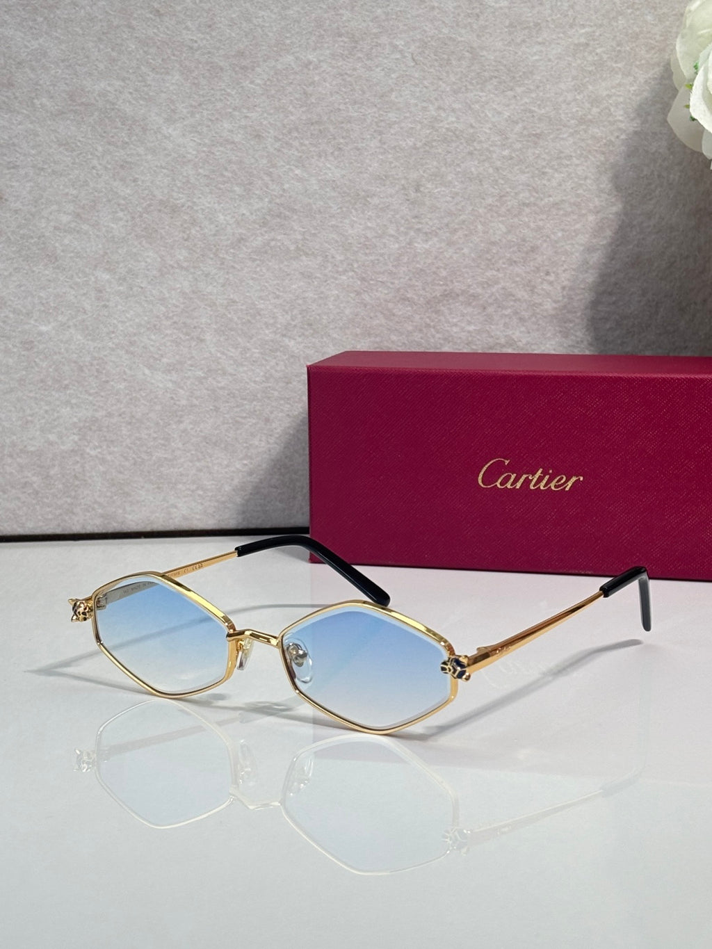 Cartier glasses, gold-tone frames with light blue lenses and black temple arms