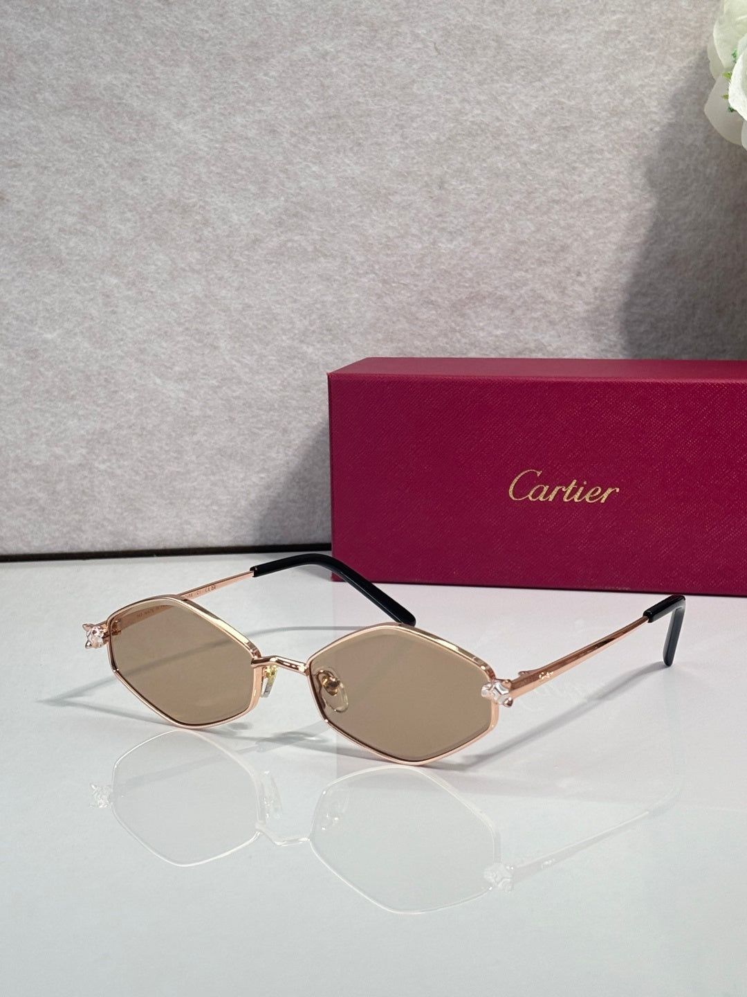 Cartier glasses, gold-tone frames with tan lenses and black temple arms
