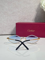 Cartier glasses, gold-tone frames with clear blue lenses and black temple arms