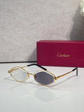 Cartier glasses, gold-tone frames with dark lenses and black temple arms