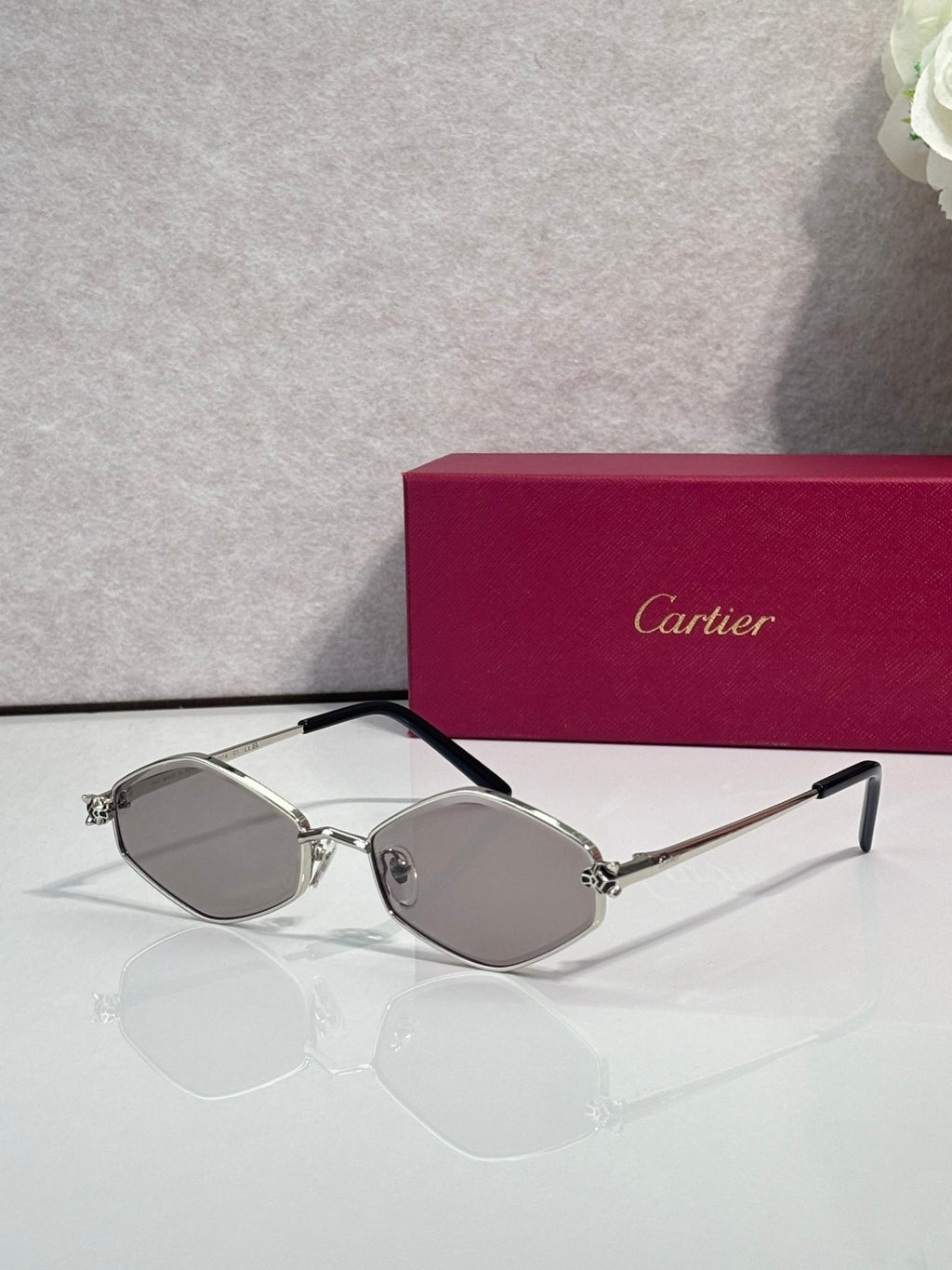 Cartier glasses, silver-tone frames with light gray lenses and black temple arms