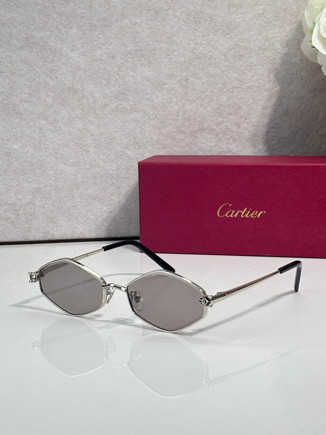 Cartier glasses, silver-tone frames with light gray lenses and black temple arms