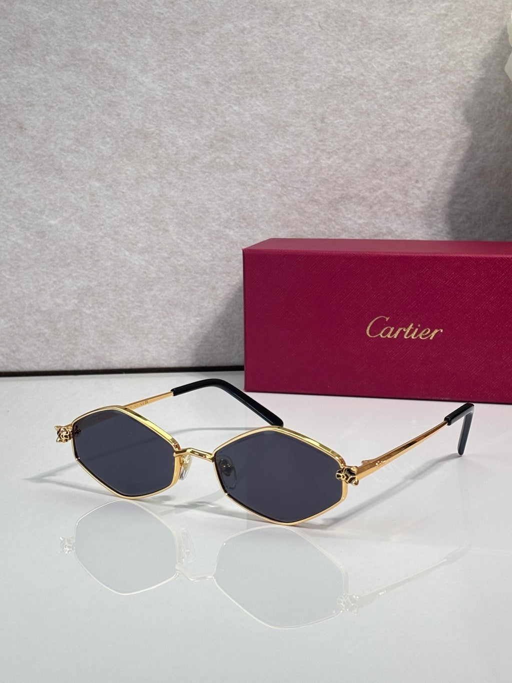 Cartier glasses, gold-tone frames with dark blue lenses and black temple arms
