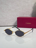 Cartier glasses, gold-tone frames with dark blue lenses and black temple arms