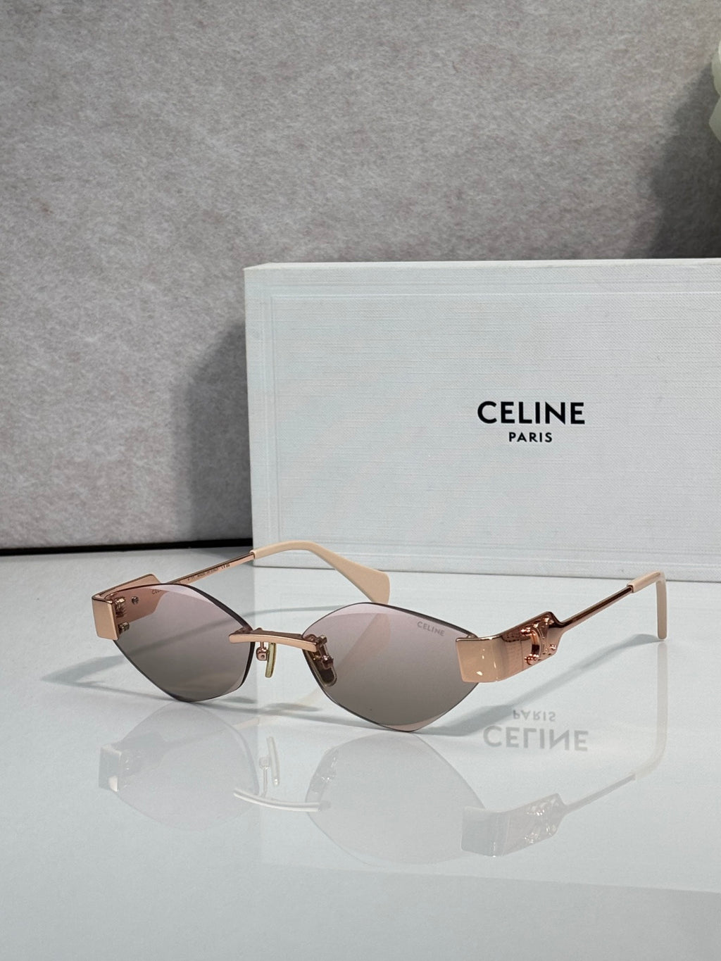 Celine sunglasses with light rose-tinted lenses and tan frame, gold-tone hardware.