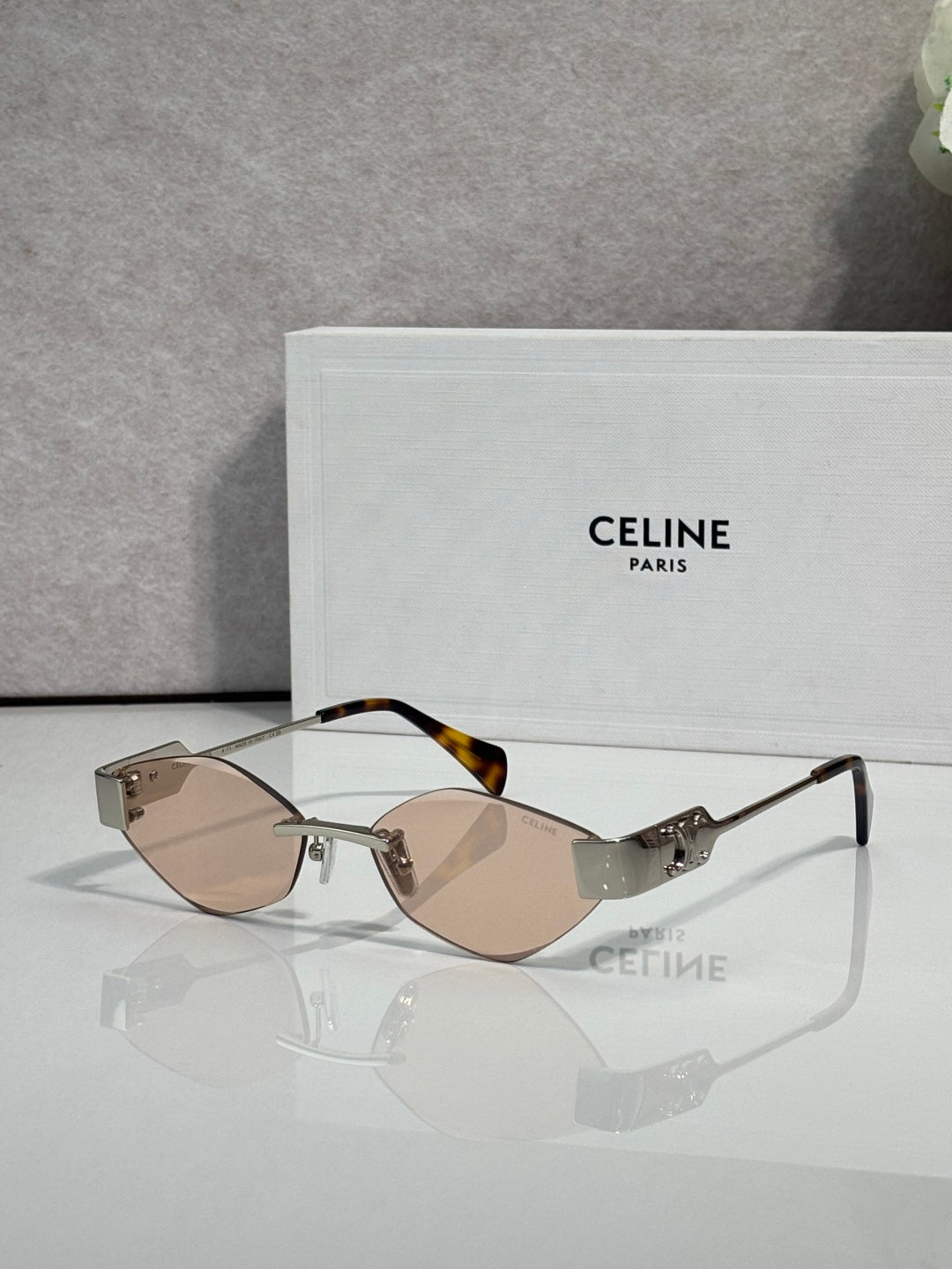 Celine sunglasses with brown-tinted lenses, tan frame, and gold-tone temples.