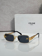 Gold-tone rectangular sunglasses, dark blue lenses, black temple accents
