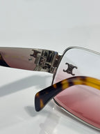 Silver-tone frames with pink-tinted lenses, tortoiseshell temple tip