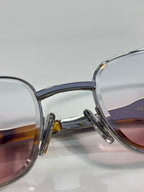 Translucent blue glasses with mauve-tinted lenses and silver metal arms