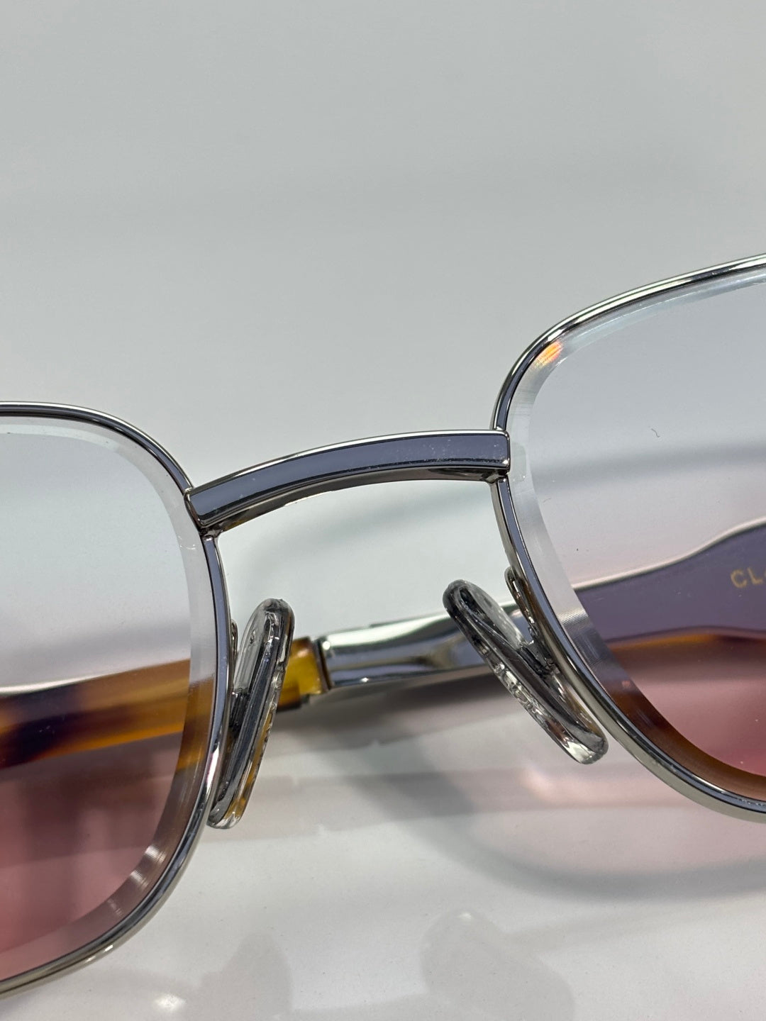 Translucent blue glasses with mauve-tinted lenses and silver metal arms