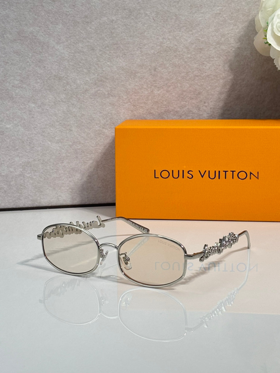 Louis Vuitton round glasses with silver frame and light gray-tinted lenses