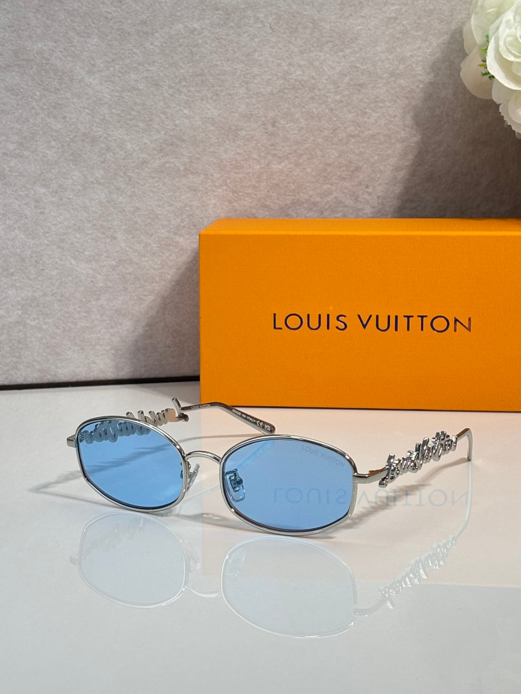 Louis Vuitton round glasses with silver frame and blue-tinted lenses