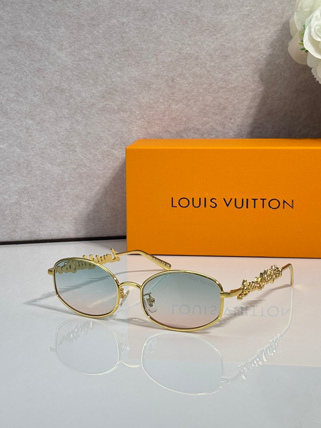 Louis Vuitton round glasses with gold frame and light green-tinted lenses