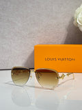 Louis Vuitton oval sunglasses with gold-tone frame and amber-tinted lenses