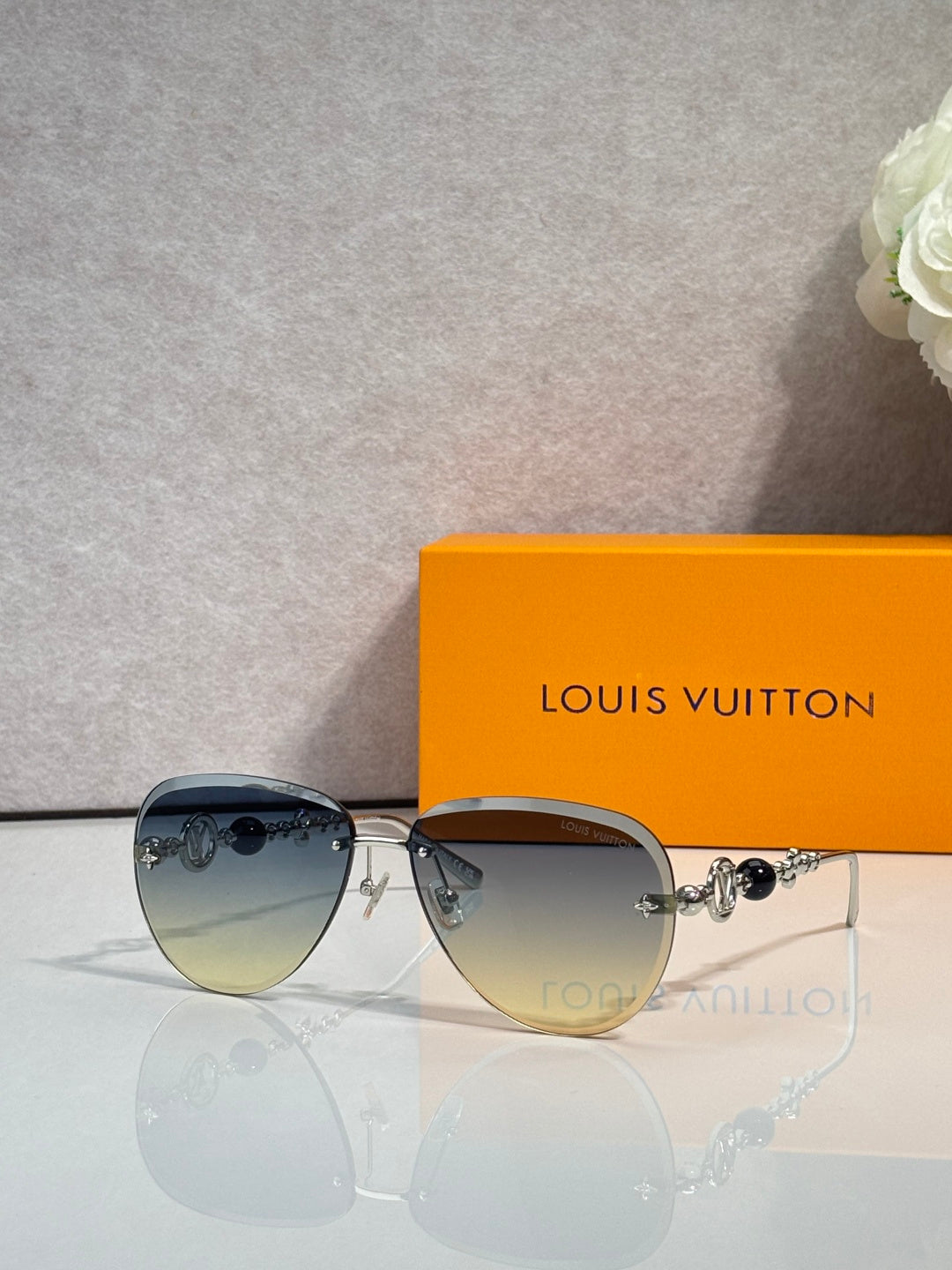Louis Vuitton oval sunglasses with navy-dark lenses and gold-tone metal frame
