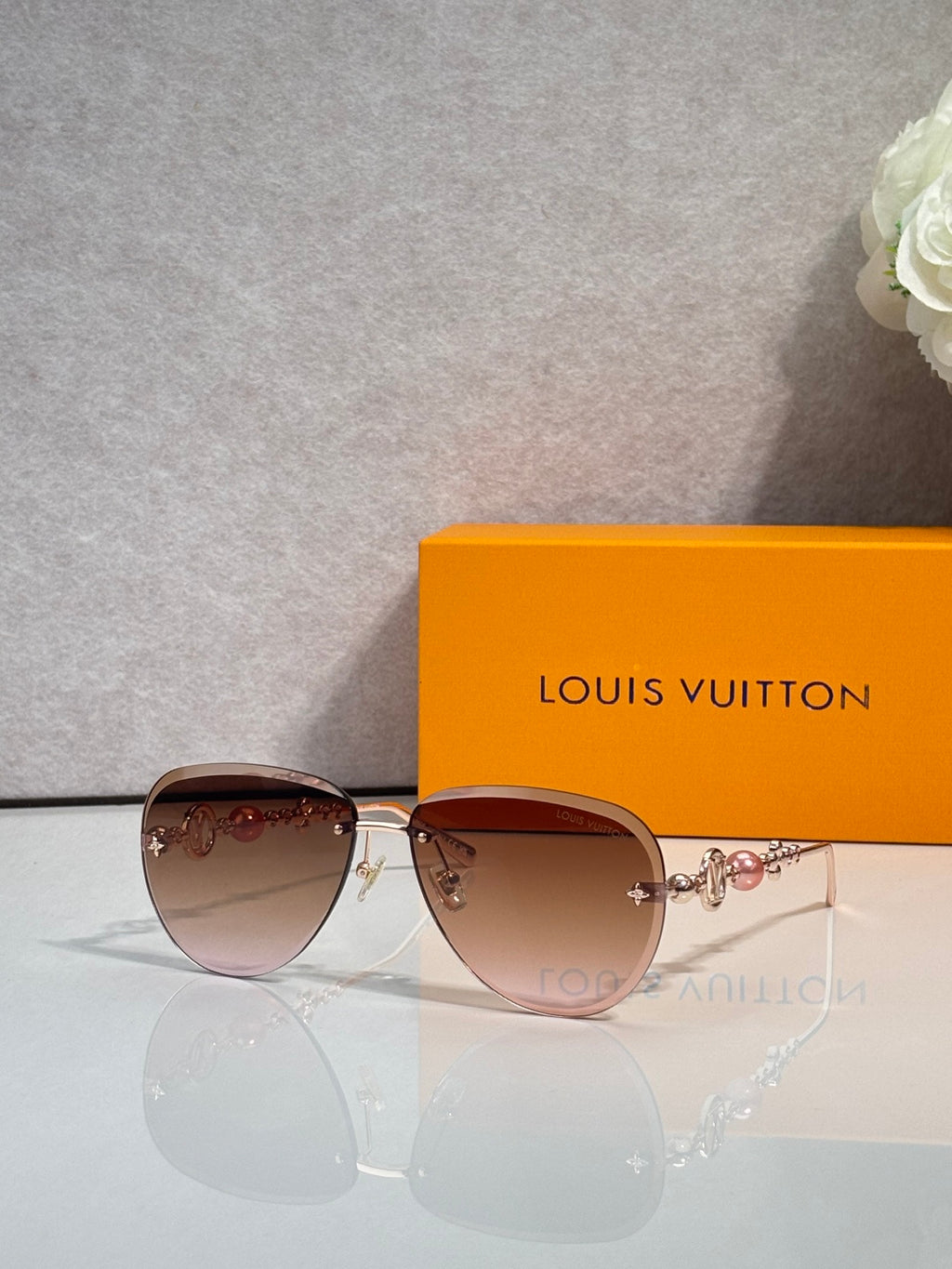 Louis Vuitton oval sunglasses with rose-brown lenses and gold-tone metal frame