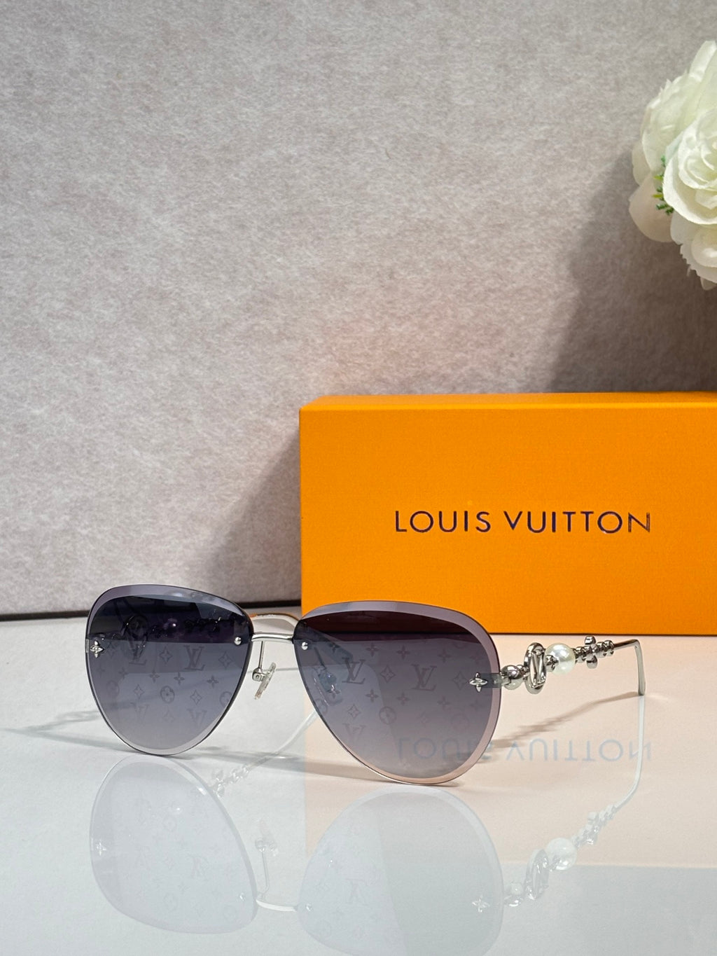Louis Vuitton oval sunglasses with dark lenses and gold-tone metal frame
