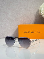 Louis Vuitton oval sunglasses with dark lenses and gold-tone metal frame