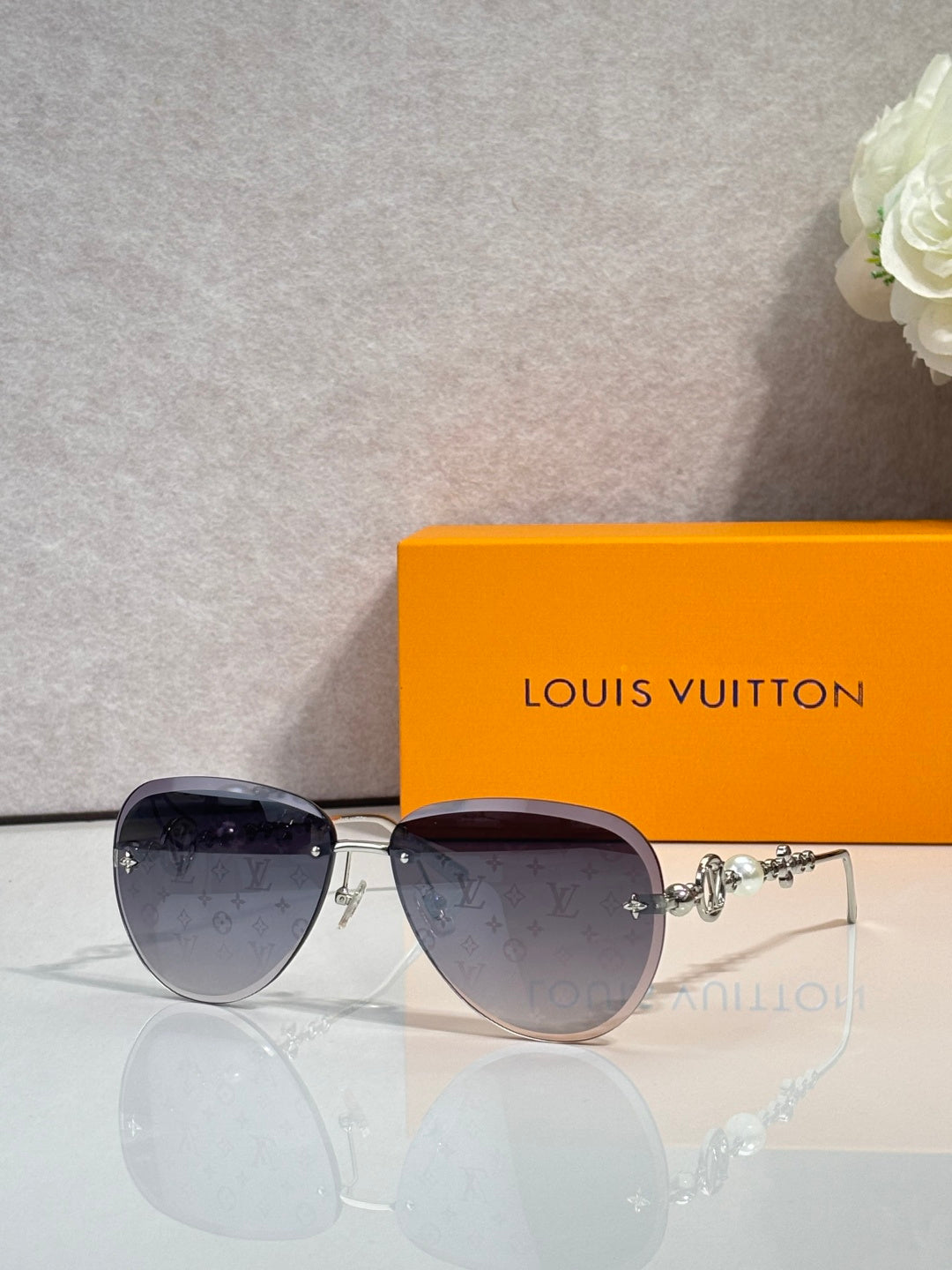 Louis Vuitton oval sunglasses with dark lenses and gold-tone metal frame
