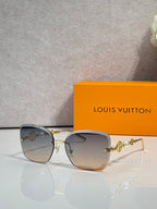 Sunglasses with light gray gradient lenses and gold-tone metal arms with charm detail