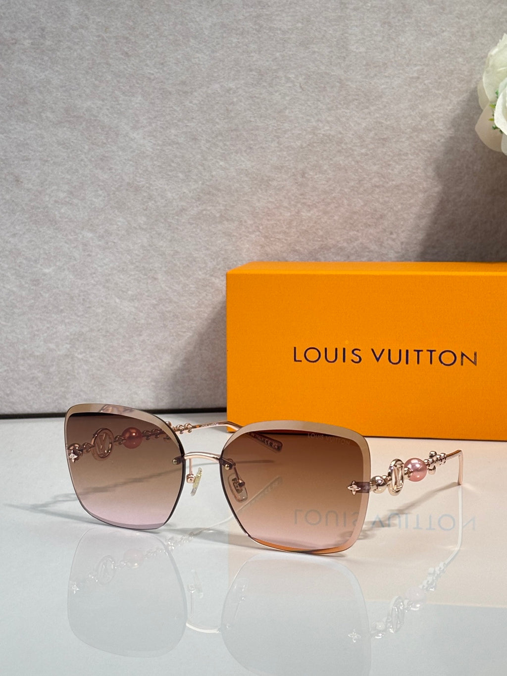 Sunglasses with brown gradient lenses and gold-tone metal frames