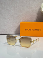 Sunglasses with amber gradient lenses and gold-tone metal frames