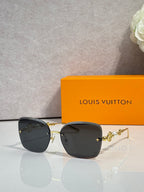 Sunglasses with black lenses and gold-tone metal temples