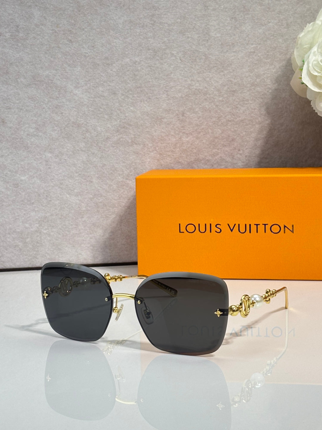 Sunglasses with black lenses and gold-tone metal temples