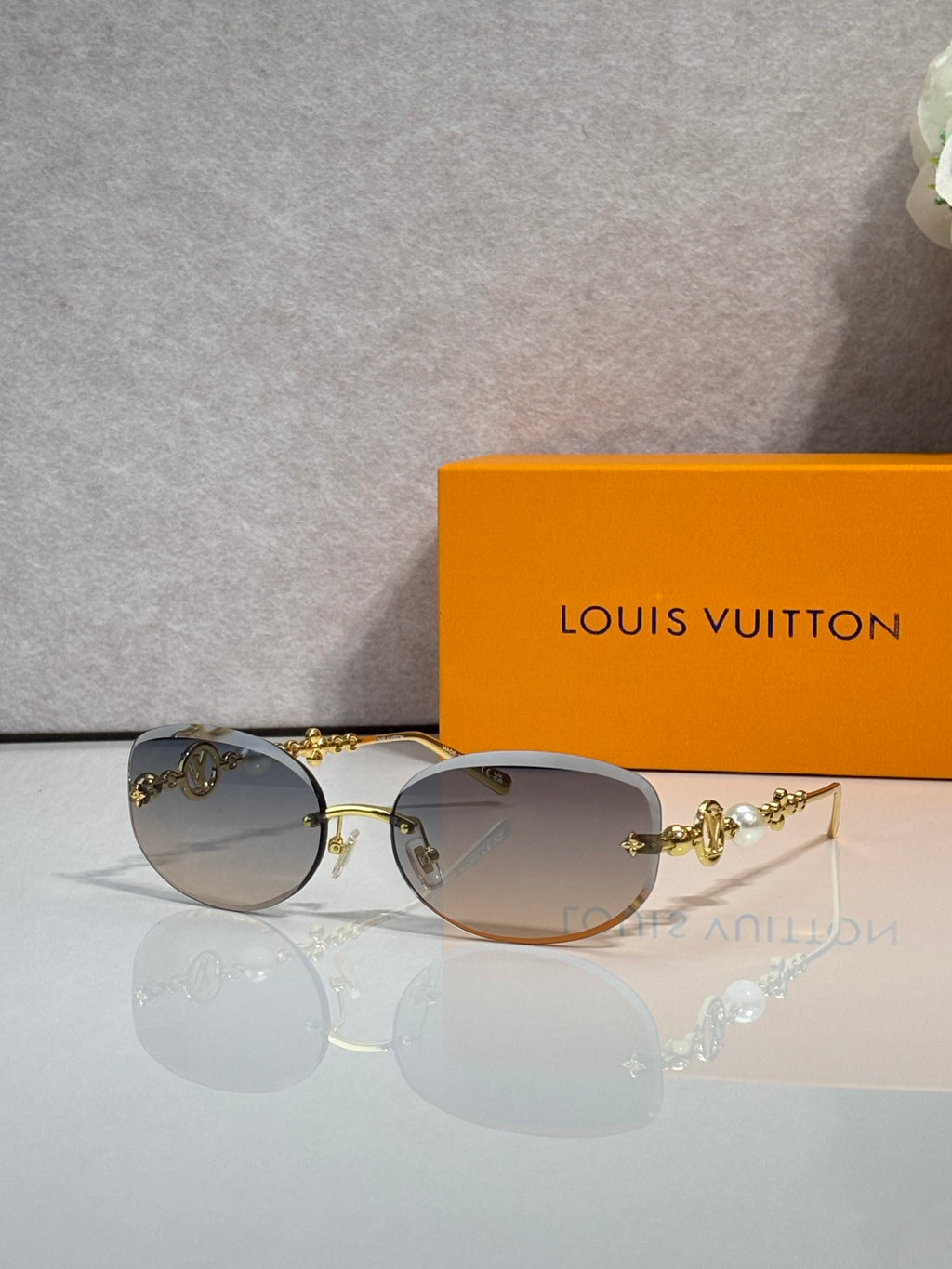 Louis Vuitton sunglasses with light brown lenses and gold metal frame