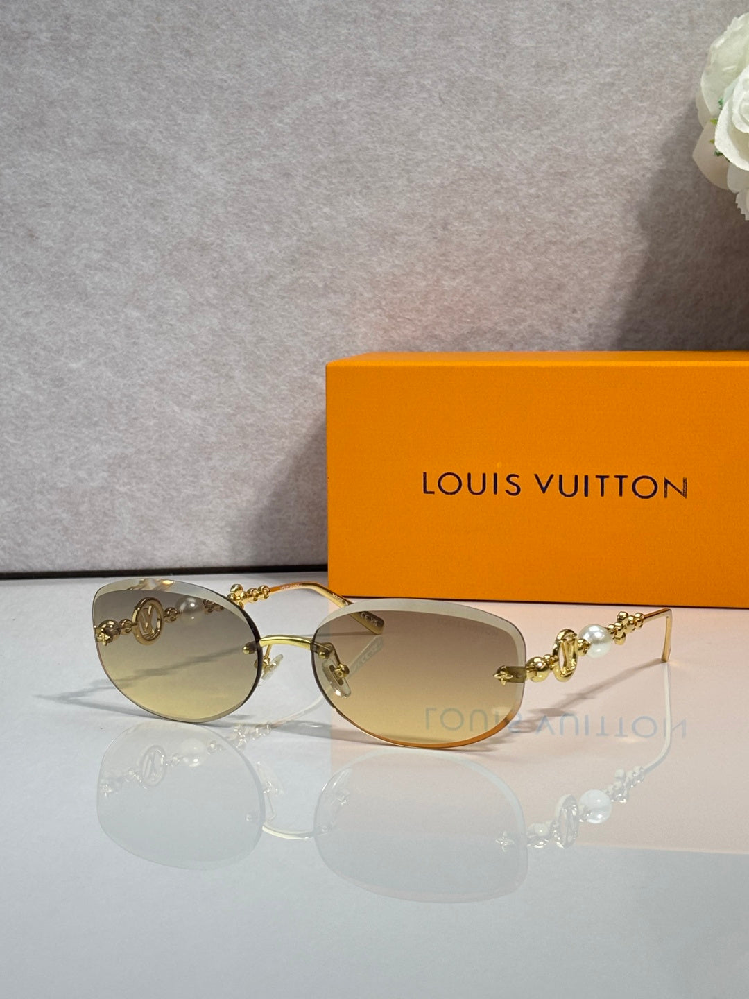 Louis Vuitton sunglasses with amber lenses and gold metal frame